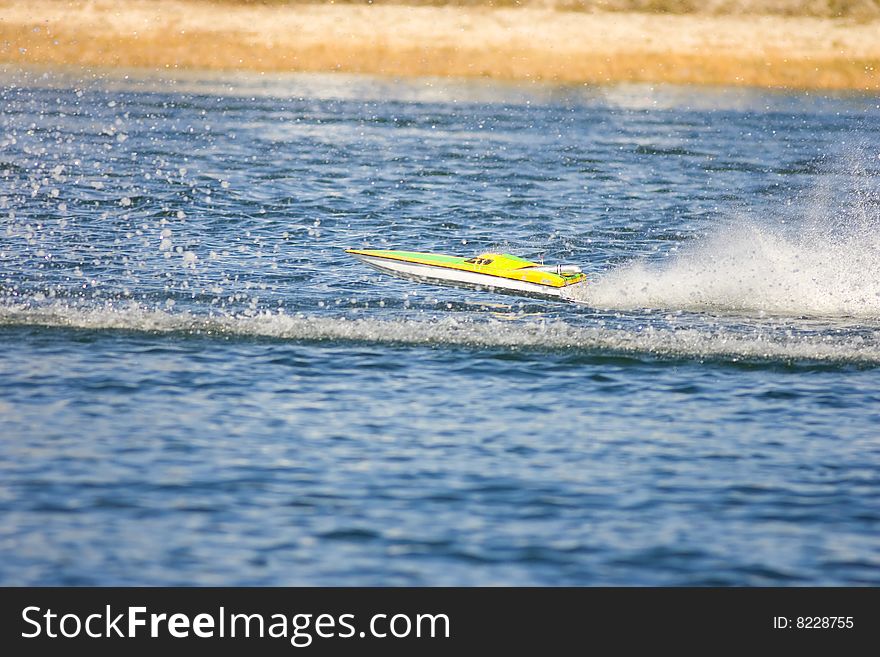 An R/C model boat hits another boats wake and goes airborne. An R/C model boat hits another boats wake and goes airborne