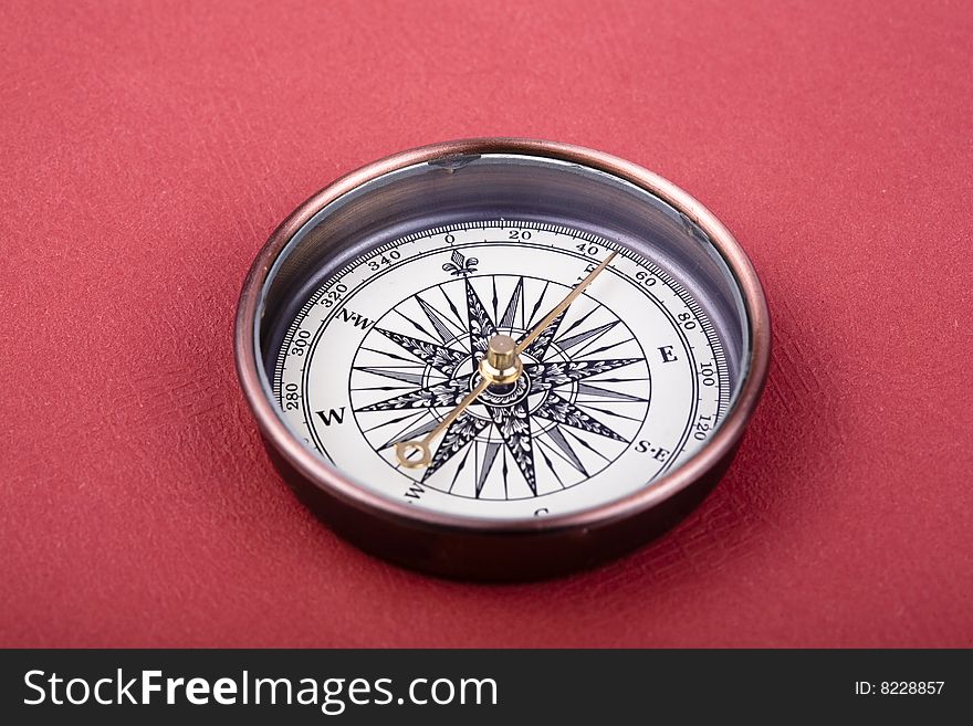 A compass on  red background