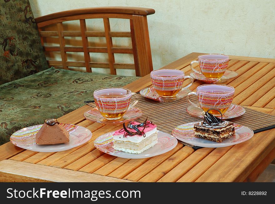 Various sweet cakes and cup of green tea on the table. Various sweet cakes and cup of green tea on the table