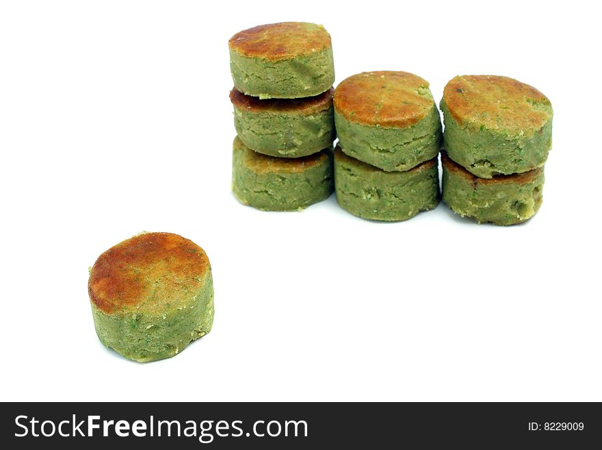 Many mung bean cakes stacked over white background.