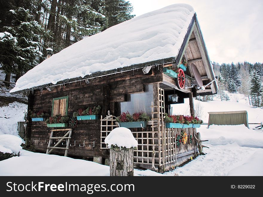 Rustic chalet covered with snow