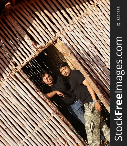 A couple of beast friends standing inside a bamboo hut, posing. A couple of beast friends standing inside a bamboo hut, posing