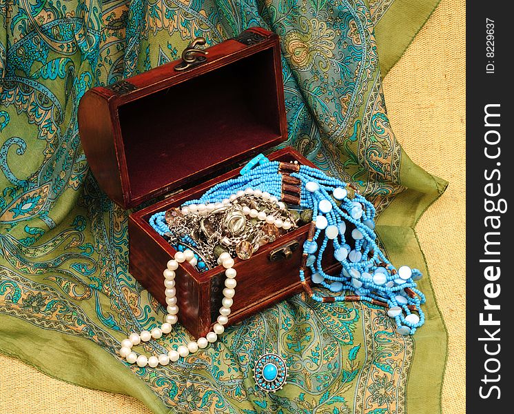 Woman accessory in wood chest on oriental background. Woman accessory in wood chest on oriental background