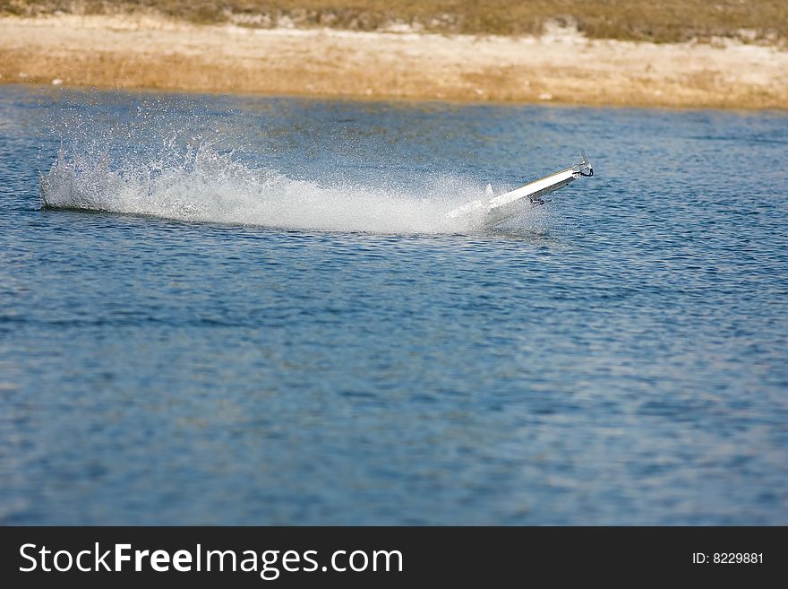 An R/C model boat goes airborne and flips over