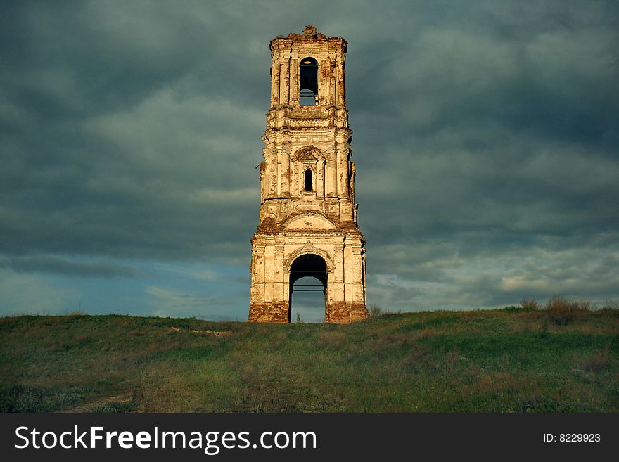 Russia. The Kachalino. The ruins of old belt-tower of the nineteenth century in dark blue sky. Russia. The Kachalino. The ruins of old belt-tower of the nineteenth century in dark blue sky.