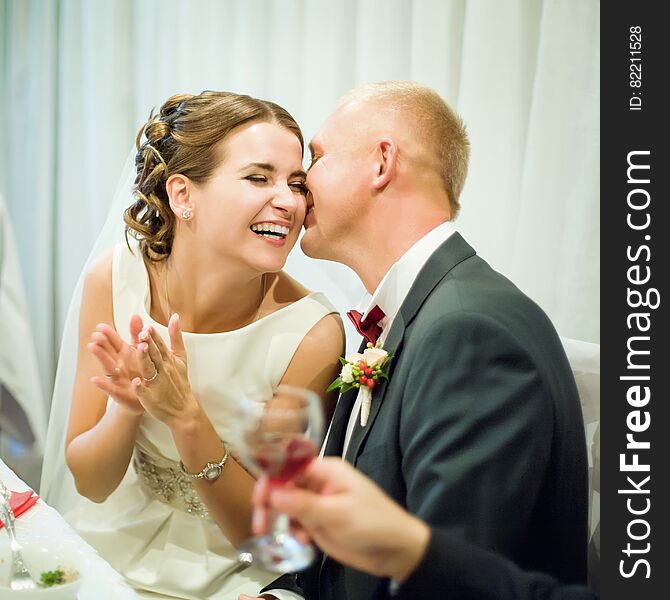 Bridal couple laughs at a banquet. Bridal couple laughs at a banquet