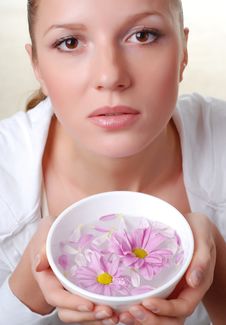 Woman And Bowl Of Flowers Royalty Free Stock Image