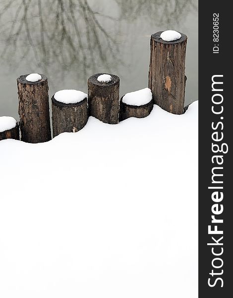 Wooden Fence In Snow.