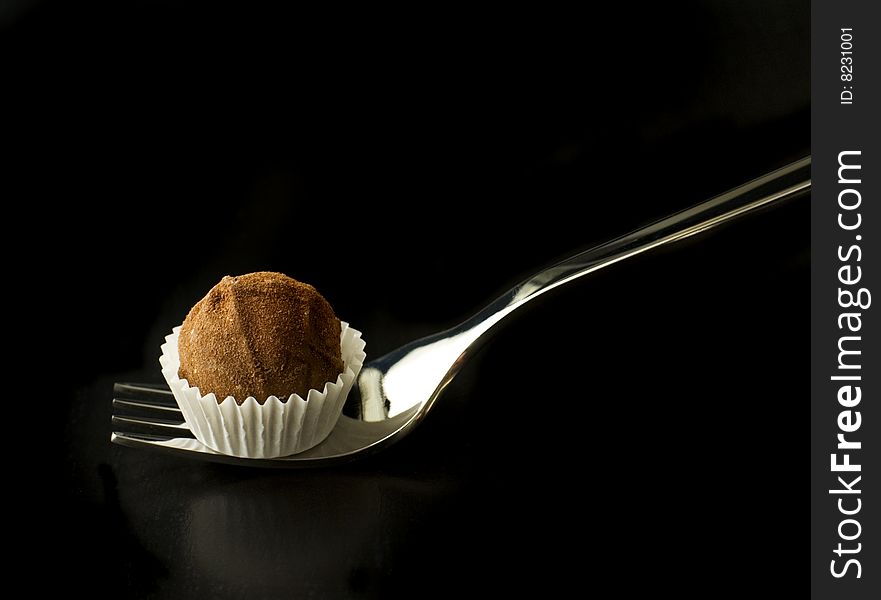 Delicious chocolate truffle on a fork