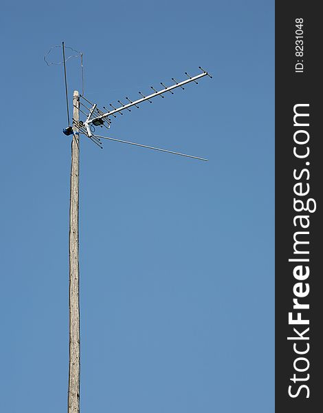 Television antenna  on a long wooden pole