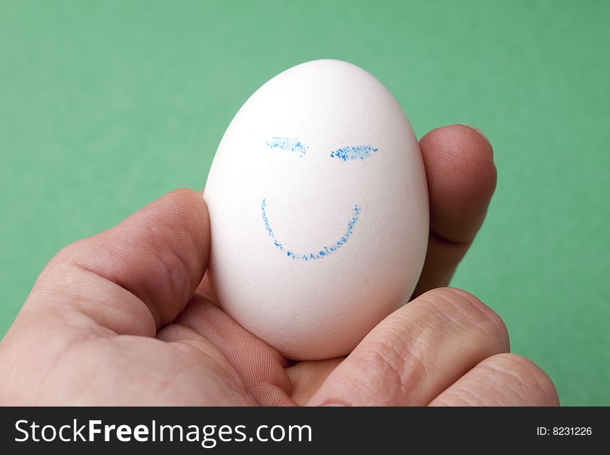 An egg decorated in blue crayon with a happy smiley face. An egg decorated in blue crayon with a happy smiley face.