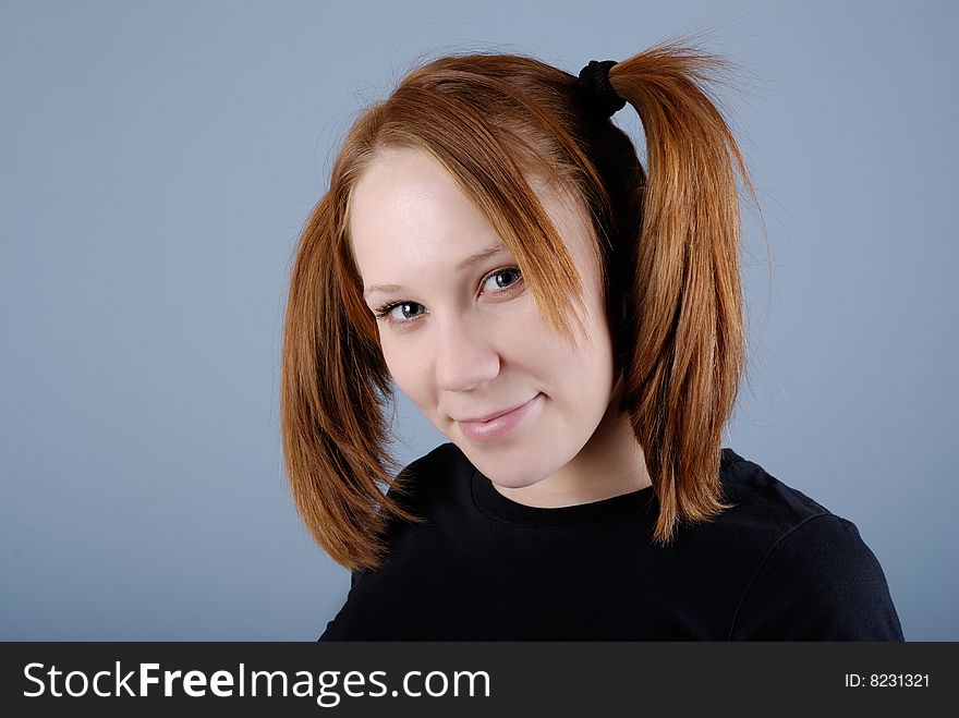 Portrait of a young beautiful woman with pigtail