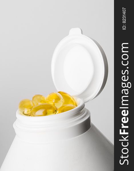 Medicine container with yellow pills