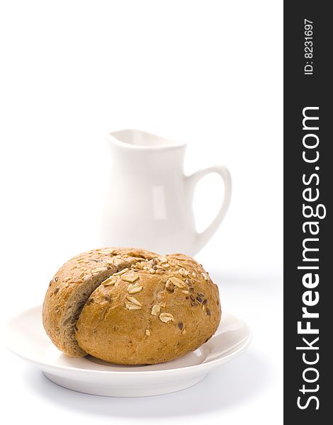 Bread and jug of milk on white background. Bread and jug of milk on white background