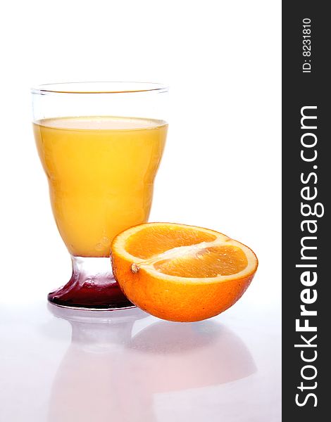 A fresh glass of juice with an orange isolated on white. A fresh glass of juice with an orange isolated on white.