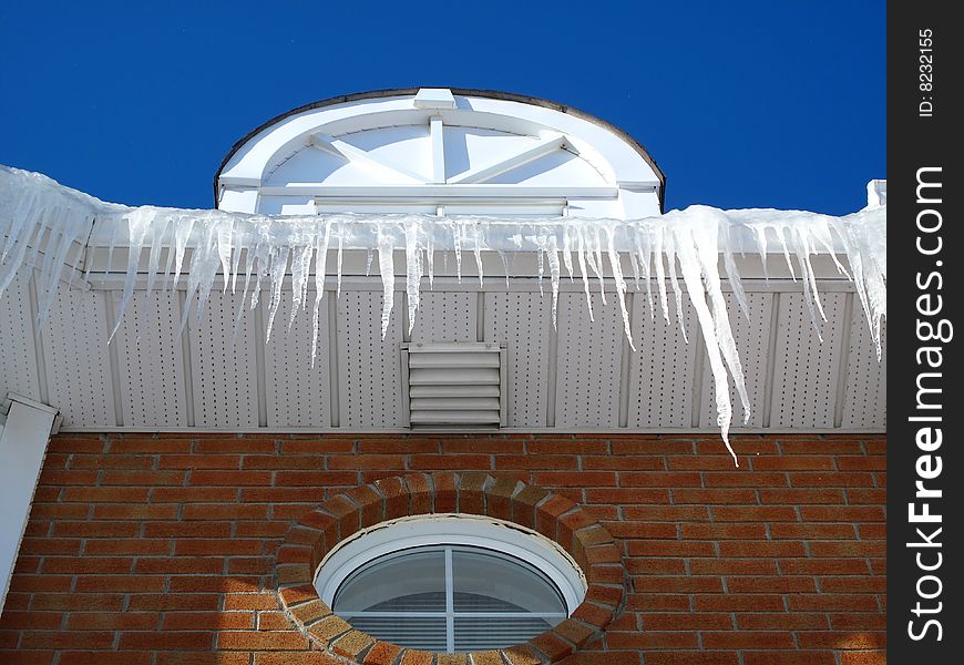 A house with icicles with a blue sky