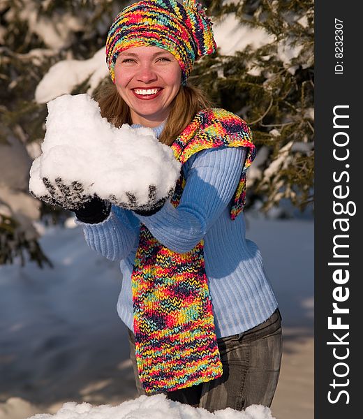 Girl keeps snowball and smiles