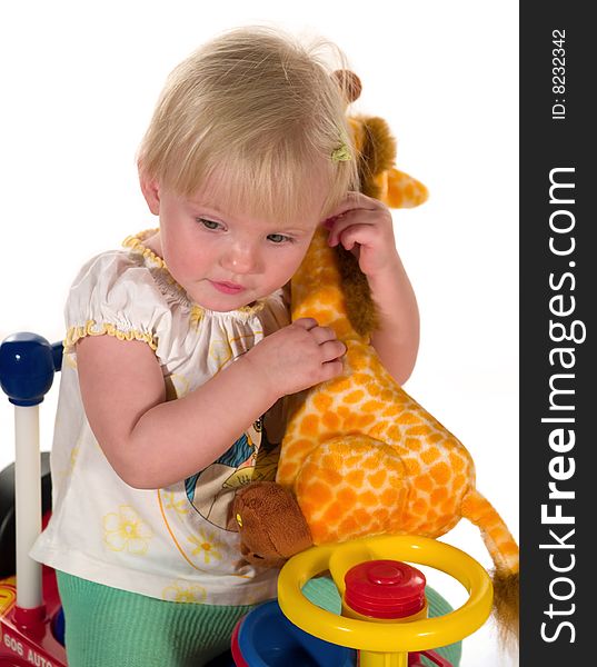 Child sits together with toy-giraffe