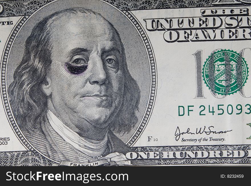 A shot of a hundred dollar bill with a black eye. A shot of a hundred dollar bill with a black eye.