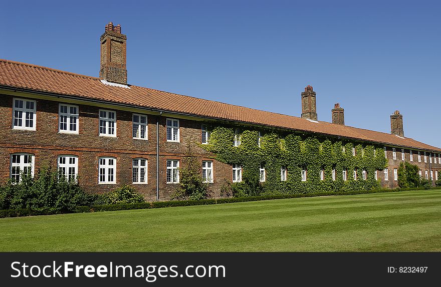 An old brick building in England covered with moss