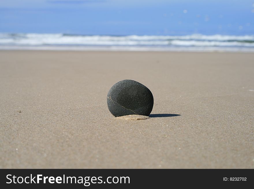 A rock in the sand at Chinamans Beach at Evans Head on the east coast of Australia. A rock in the sand at Chinamans Beach at Evans Head on the east coast of Australia.