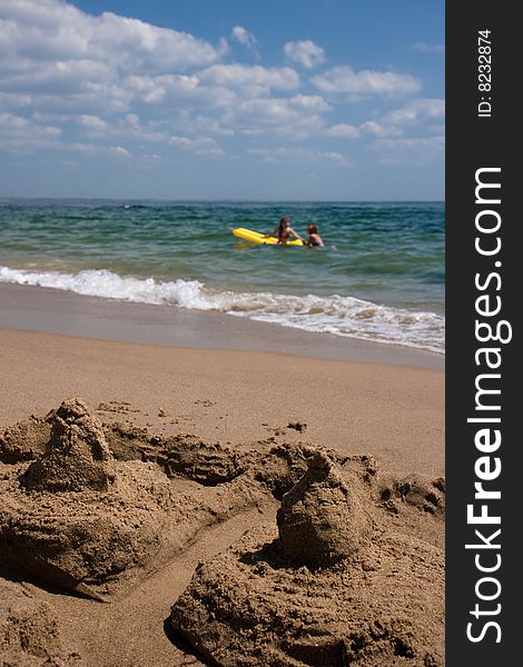 The sand lock against the sea in which two girls bathe. The sand lock against the sea in which two girls bathe