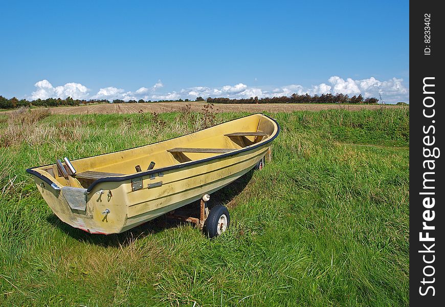 Small fishing Skiff boat on the seashore green field. Small fishing Skiff boat on the seashore green field