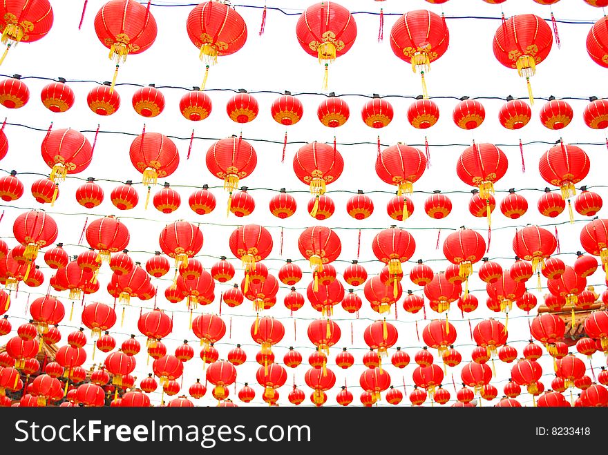 Red chinese lanterns hanging around the chinese temple.