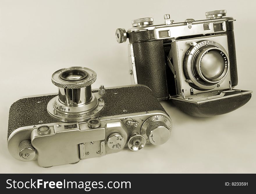 Two antiquarian 35-mm film cameras with put-forward lens. Two antiquarian 35-mm film cameras with put-forward lens.