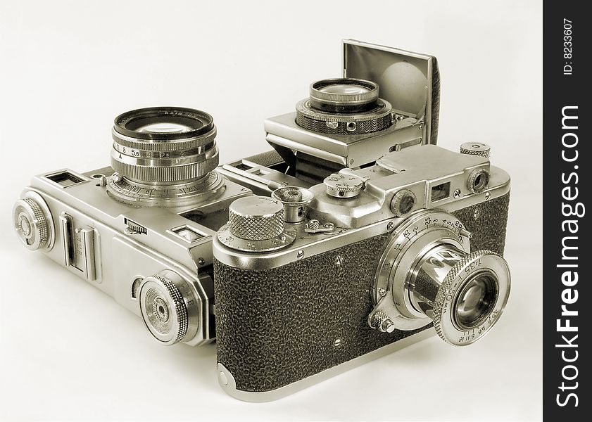 Three antiquarian 35-mm film cameras with put-forward lens. Three antiquarian 35-mm film cameras with put-forward lens.