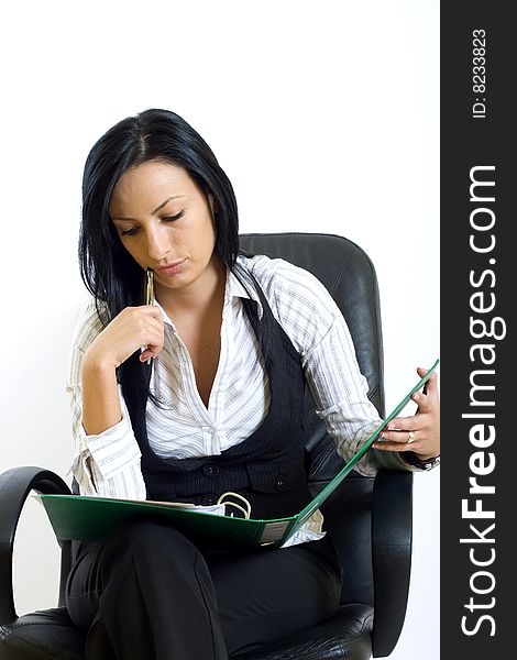 Attractive businesswoman in office chair with folder and pen