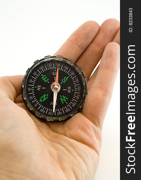 Compass in a hand on a white background