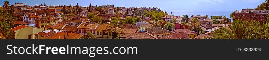 Panorama of beautiful Mediterranean city Antaliya house tiled roofs in clear summer weather. Panorama of beautiful Mediterranean city Antaliya house tiled roofs in clear summer weather