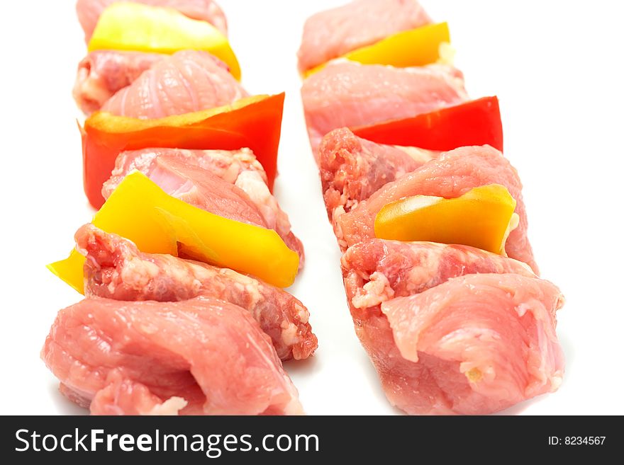 Raw meat and fresh vegetables on skewers ready to be cooked. Shallow DOF. Raw meat and fresh vegetables on skewers ready to be cooked. Shallow DOF