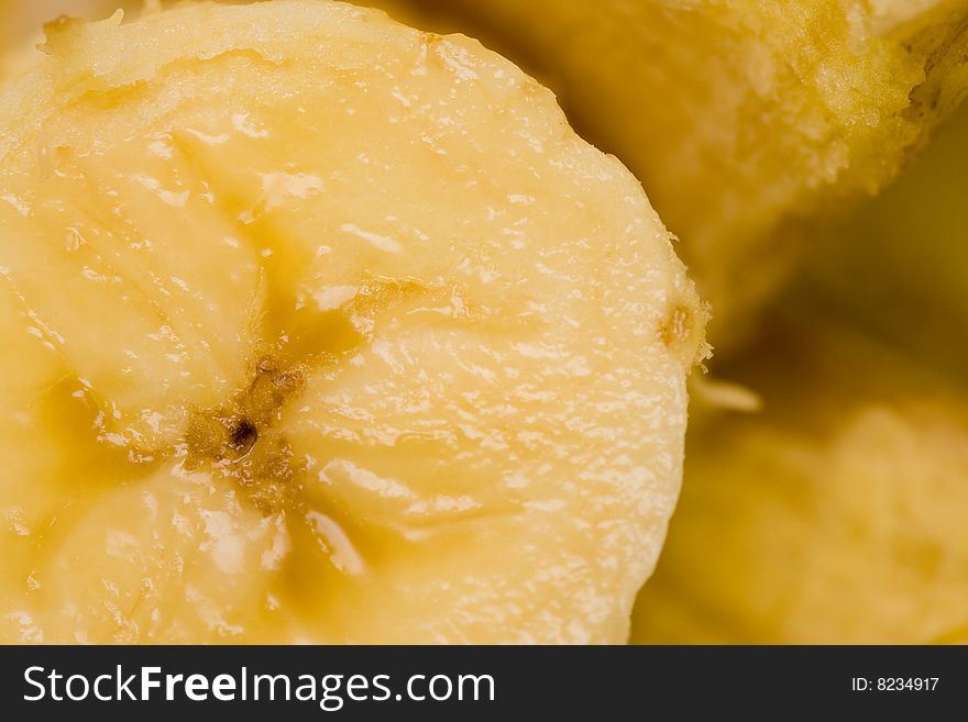 Closeup of cut banana with peel in background. Closeup of cut banana with peel in background