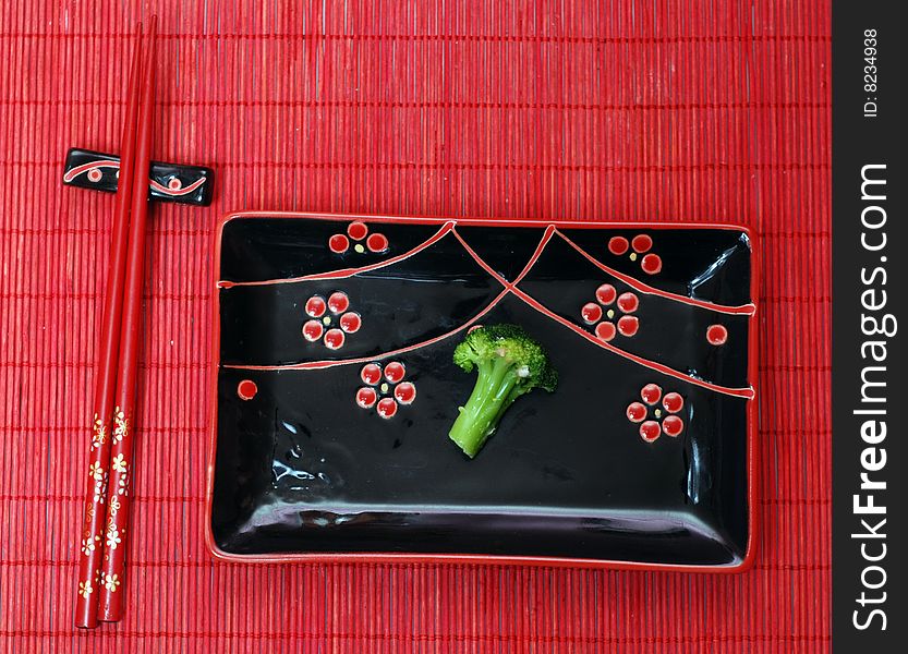 Set of black chinese ceramics kitchen utensils and broccoli