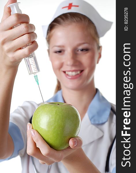 Nurse with syringe make injection in green apple. Nurse with syringe make injection in green apple