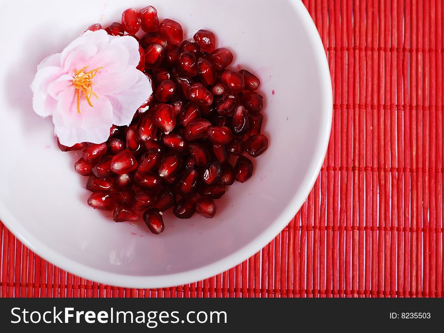 Red seeds of sweet pomegranate in white bowl. Red seeds of sweet pomegranate in white bowl