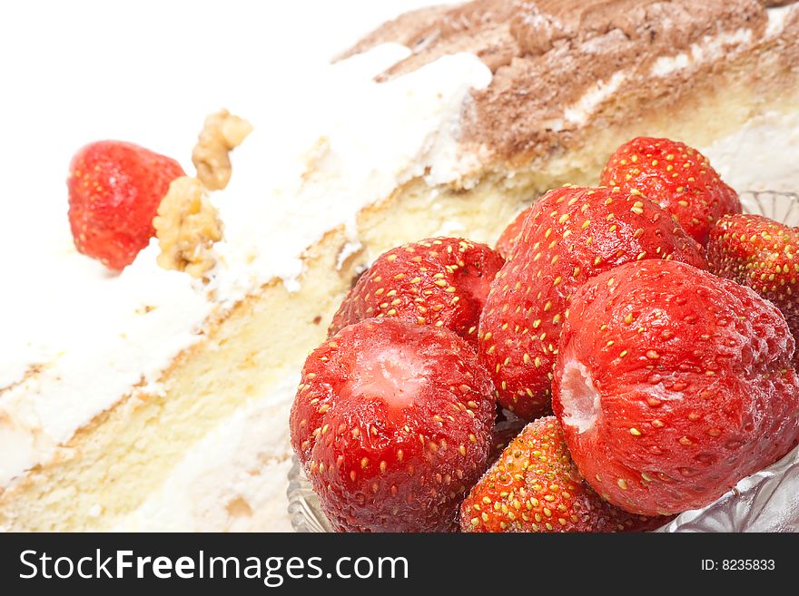 Cream cake with strawberry glaze and berries.