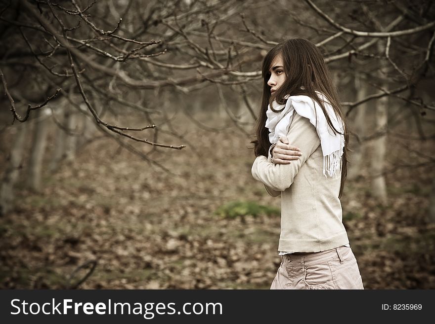 Young pensive woman in dark scenery. Young pensive woman in dark scenery.