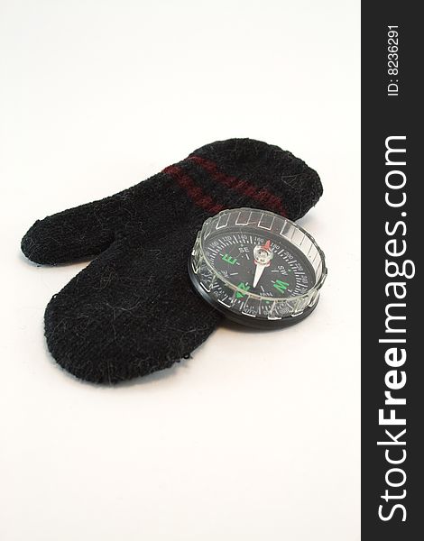 Compass and mitten on a white background