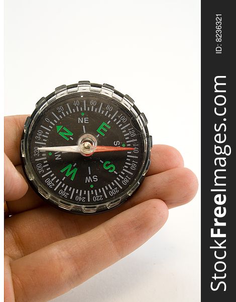 Compass in a hand on a white background