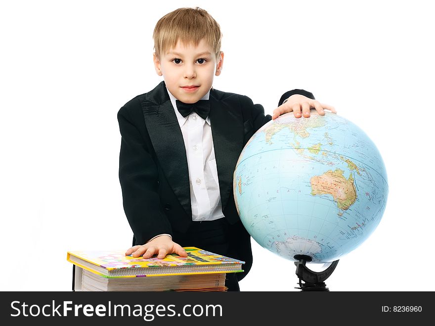 Little schoolboy with books and a globe against white background. Little schoolboy with books and a globe against white background