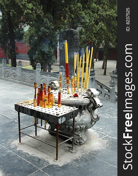 Offering burning incense sticks to Buddha, China, Shaolin