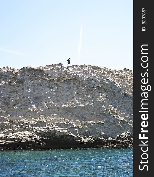 Man on top of a sea cliff. Man on top of a sea cliff