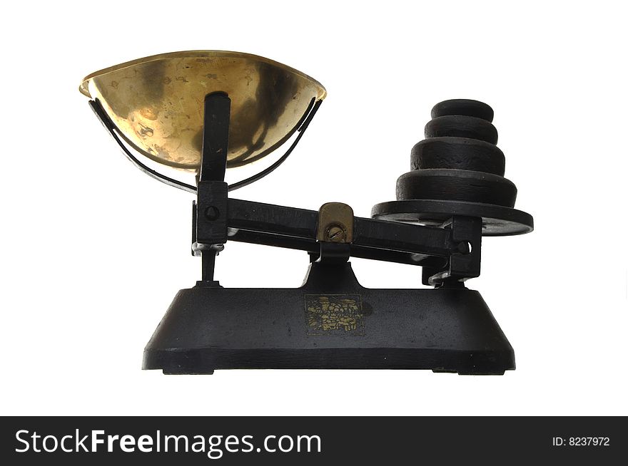 Old fashioned cast iron kitchen scale with brass pan and black metal weights. Old fashioned cast iron kitchen scale with brass pan and black metal weights