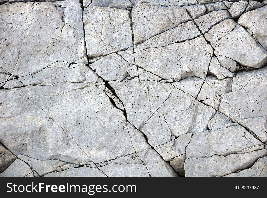 Cracked hard stone as background