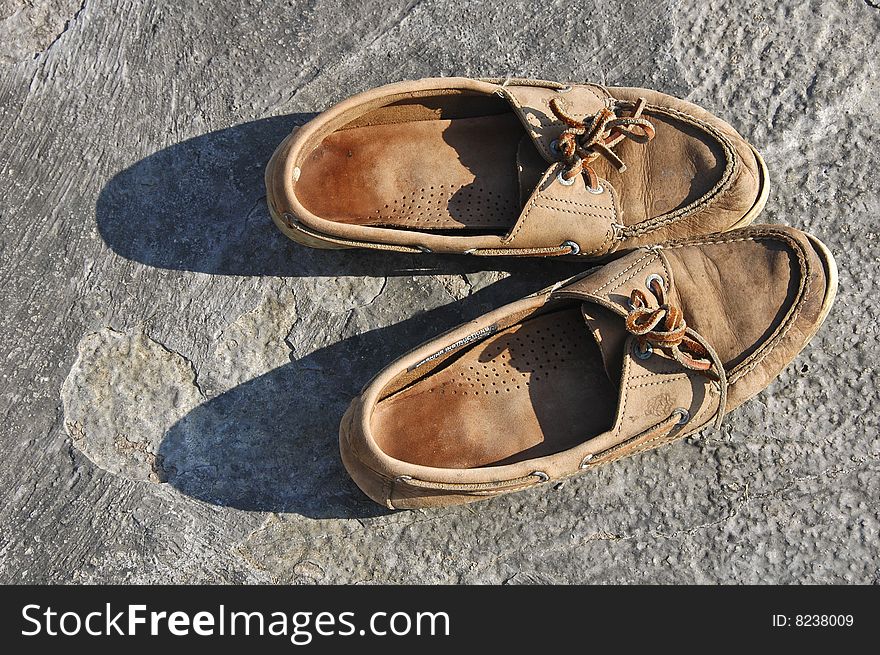 Old sport shoes in the summer sun