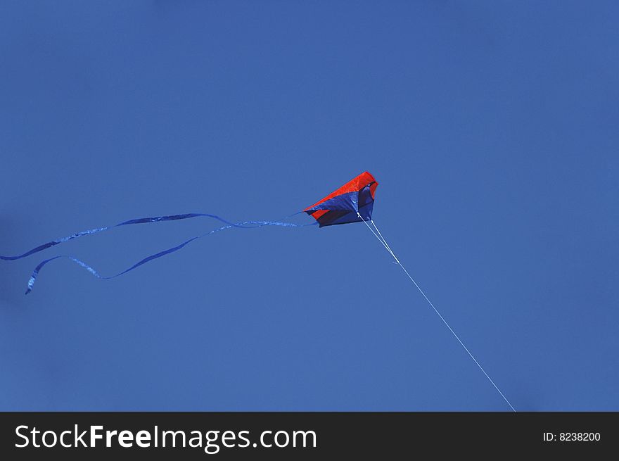 Colored kite flying in the blue sky