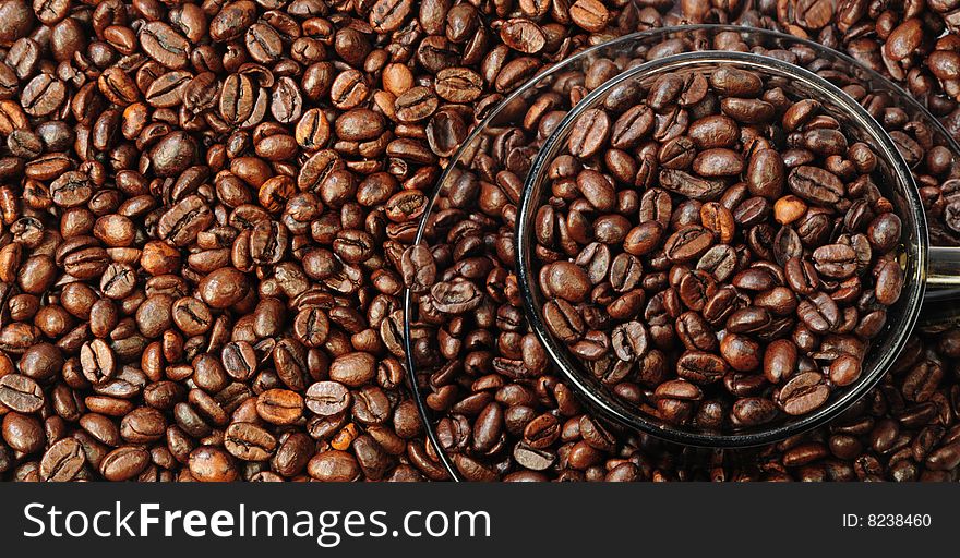 There are outlines of cup and saucer in-bulk coffee grains as background. There are outlines of cup and saucer in-bulk coffee grains as background